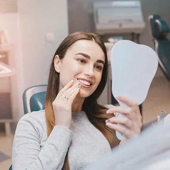female-checking-her-smile-570x570