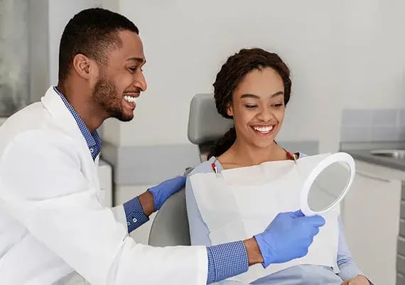 female-with-dentist-at-exam-570x401