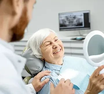 smiling-elderly-woman-with-dentist-359x326