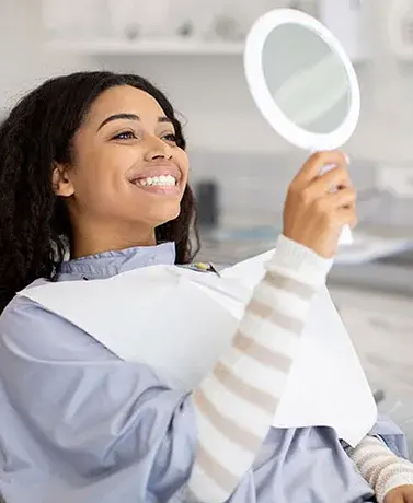 young-woman-checking-her-smile-377x460